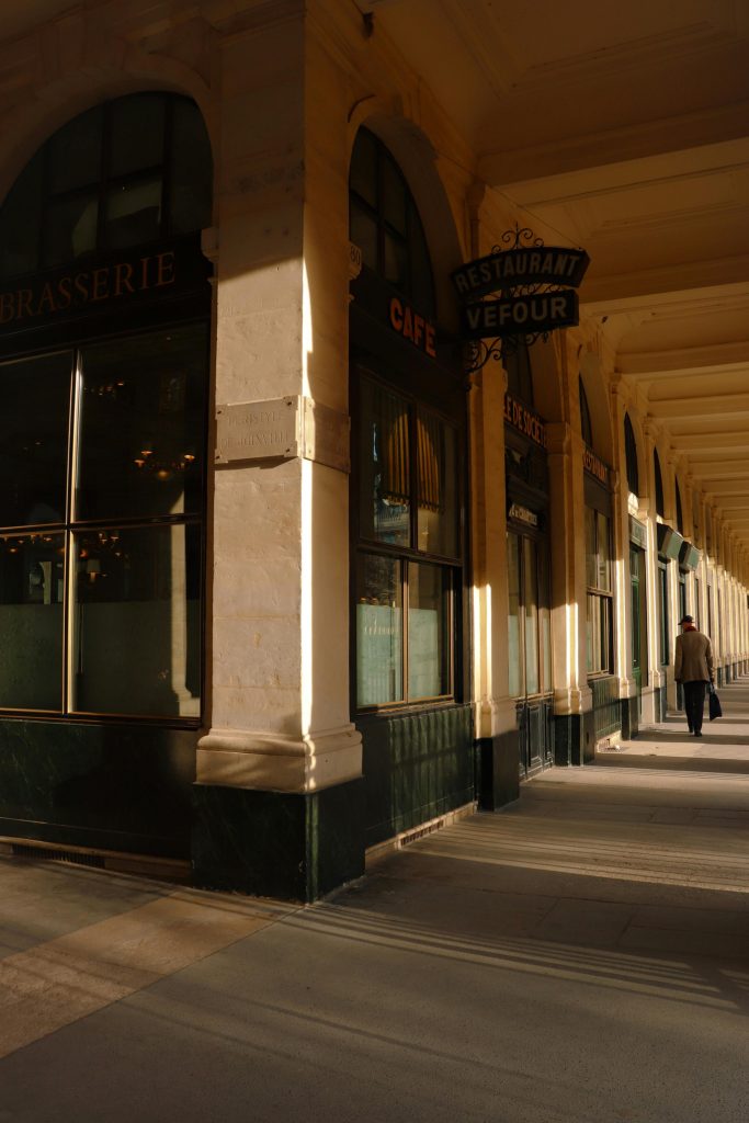 pexels photo 15190885 15190885 Sunlit corridor of Paris' Palais Royal highlighting classic architecture.